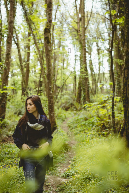 Woman hiking in countryside at forest