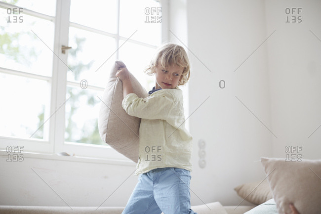 Boy holding pillow preparing to throw