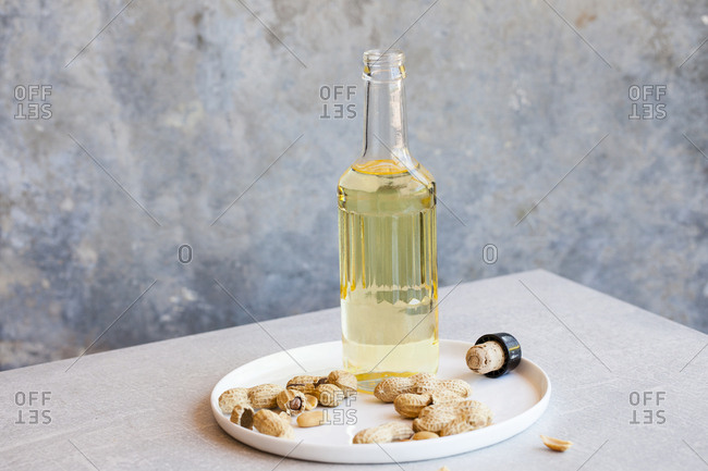 Peanuts with a bottle of peanut oil