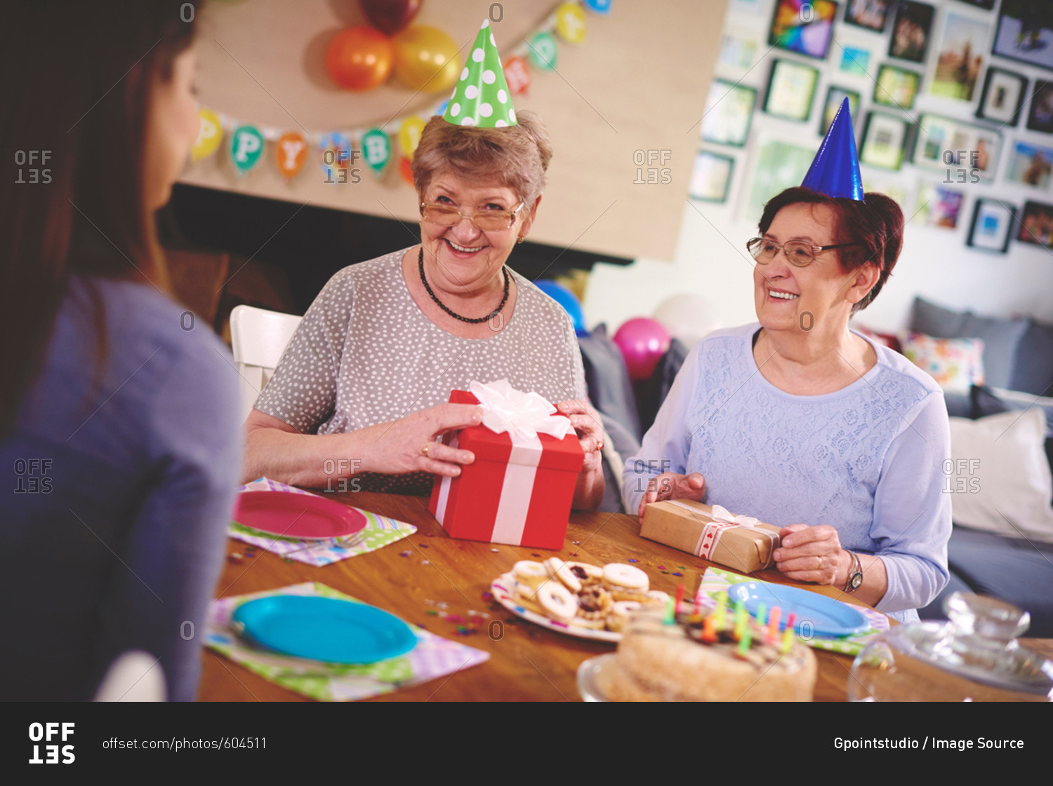 Daughter talking to mother and friend at birthday party