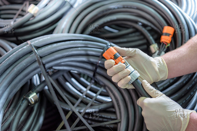 Electrical engineer holding cables in cable finishing factory