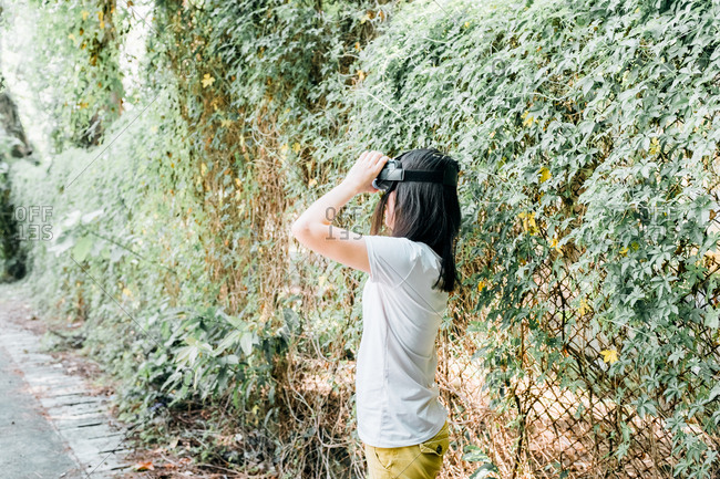 Asian woman with virtual reality headset outdoor