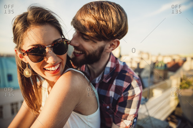 Austria- Vienna- Young couple enjoying romantic sunset on rooftop ...