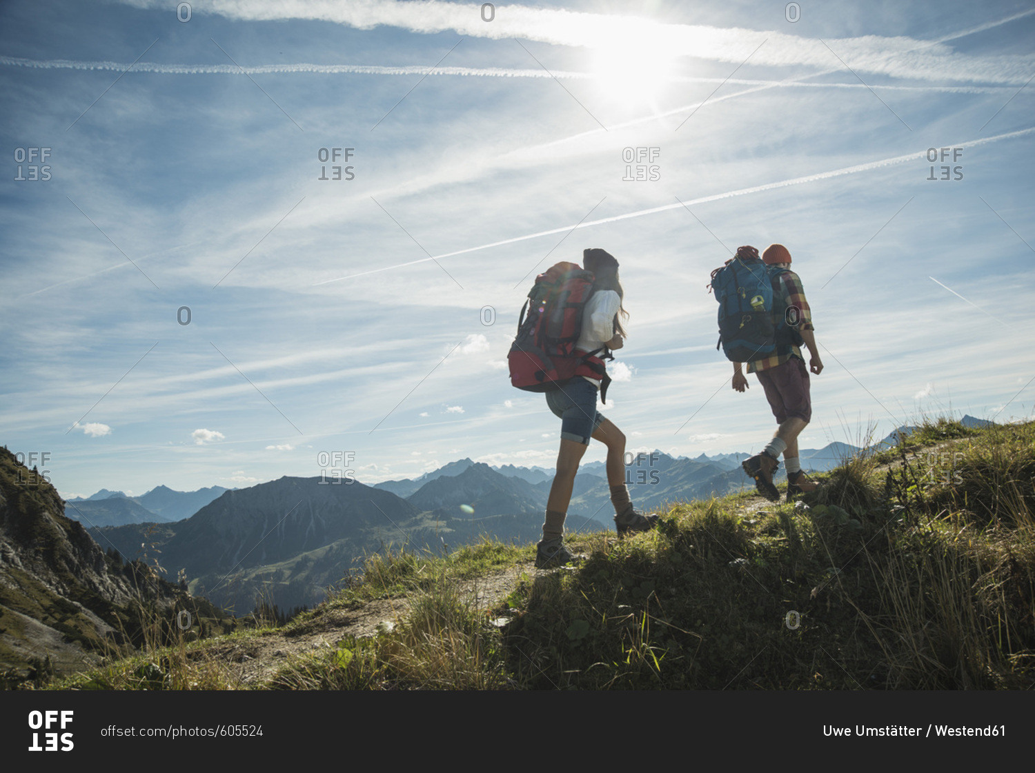 Austria- Tyrol- Tannheimer Tal- young couple hiking on mountain trail