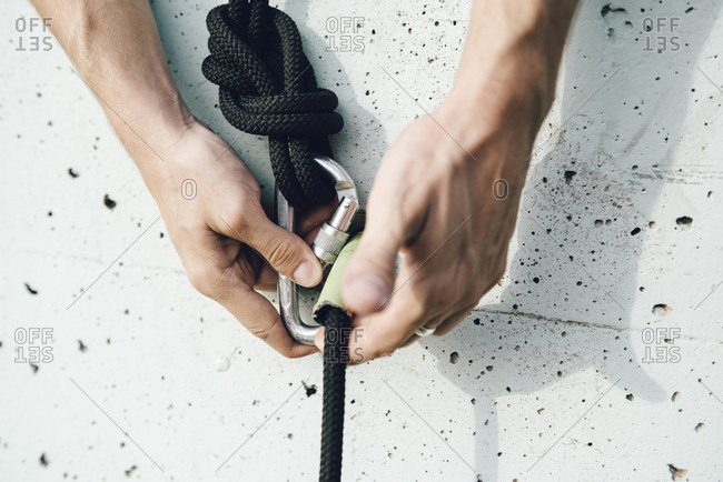Close up of aerial dancer hands handling ropes for safety in a wall