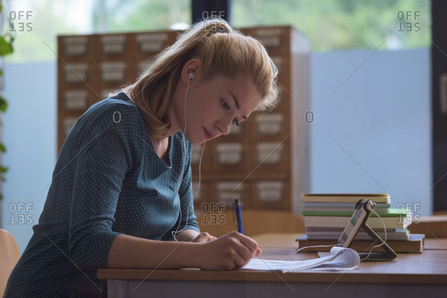 University student completing assignment in class at college