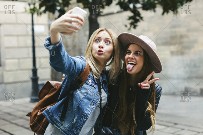 Two playful young women taking a selfie