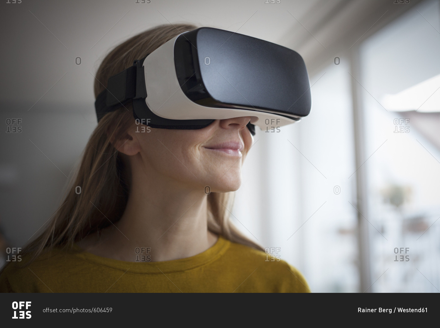 Smiling woman wearing Virtual Reality Glasses