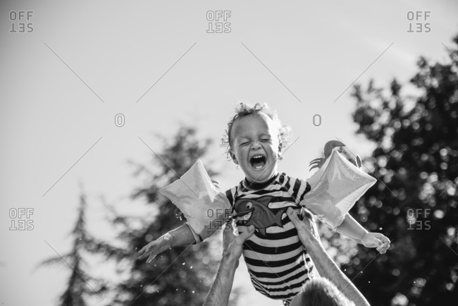 Happy young by lift in air by his father