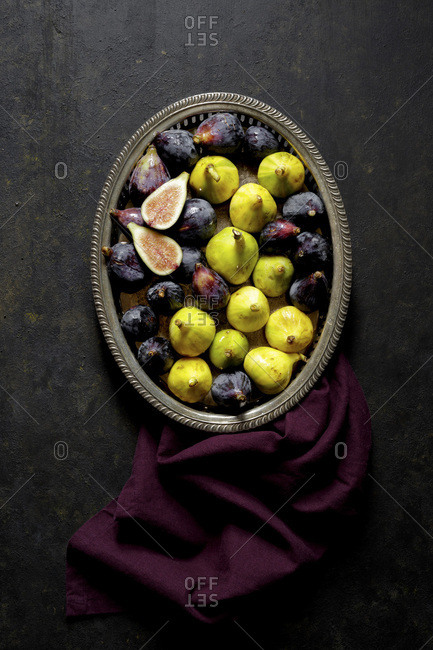 Fresh Figs in a metal tray on a black background