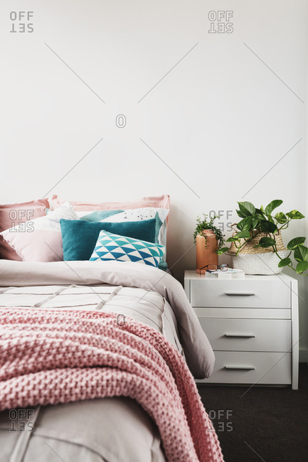 Modern styled feminine bedroom decor and indoor plant