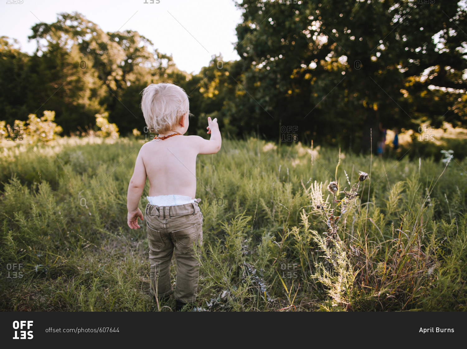 A toddler boy standing outside stock photo - OFFSET