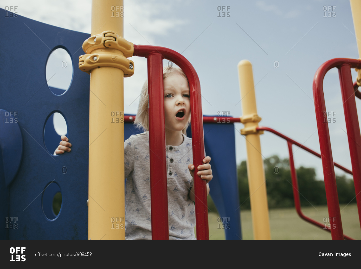 Boy playing on outdoor play equipment at playground