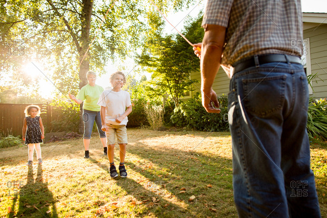 Grandparents skipping rope with kids