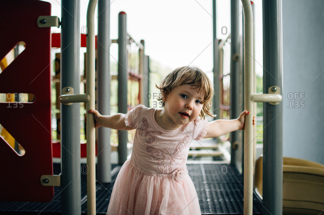 Little girl playing on a play set