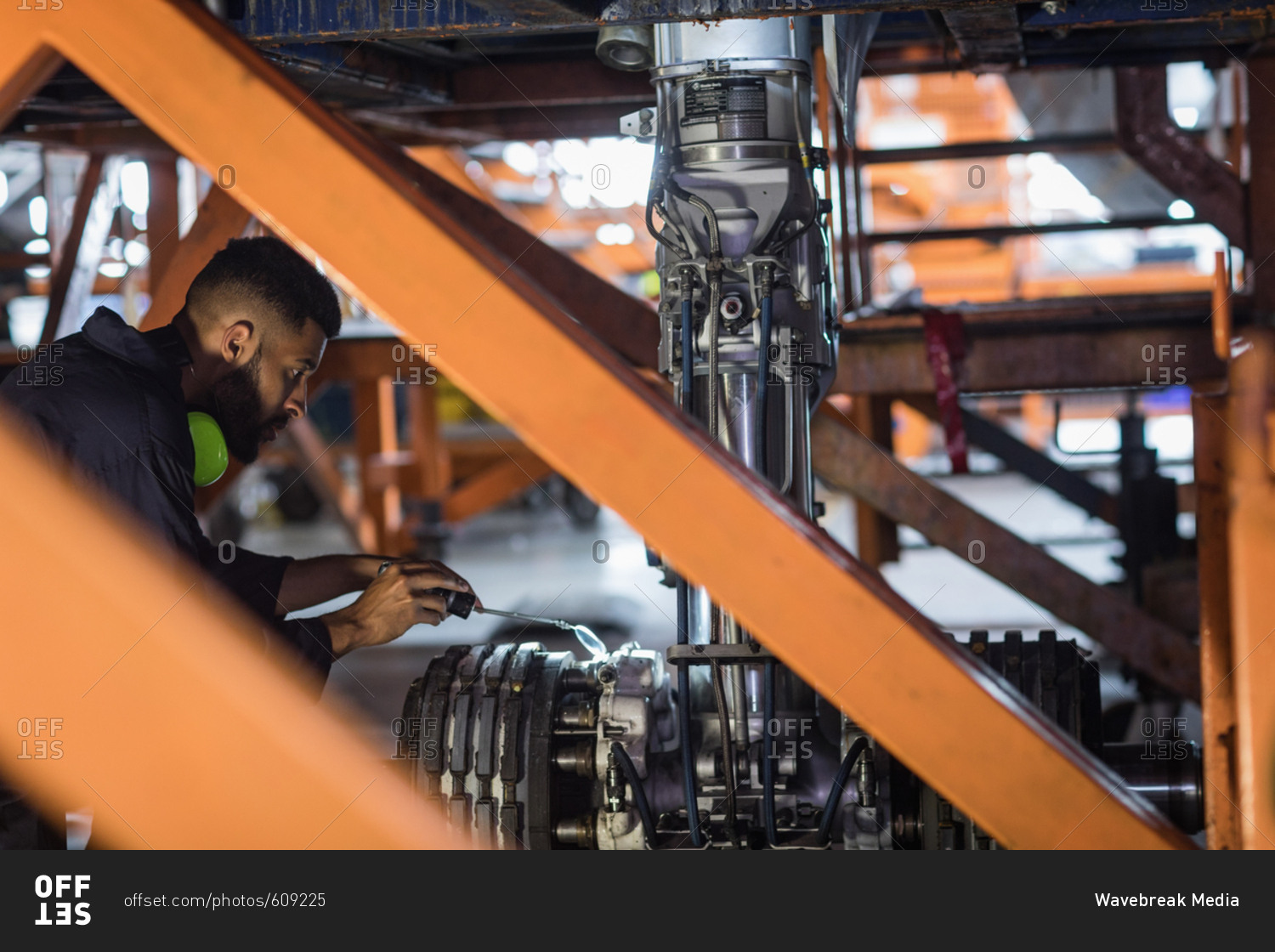 aircraft-maintenance-engineer-working-over-chassis-of-an-aircraft-at