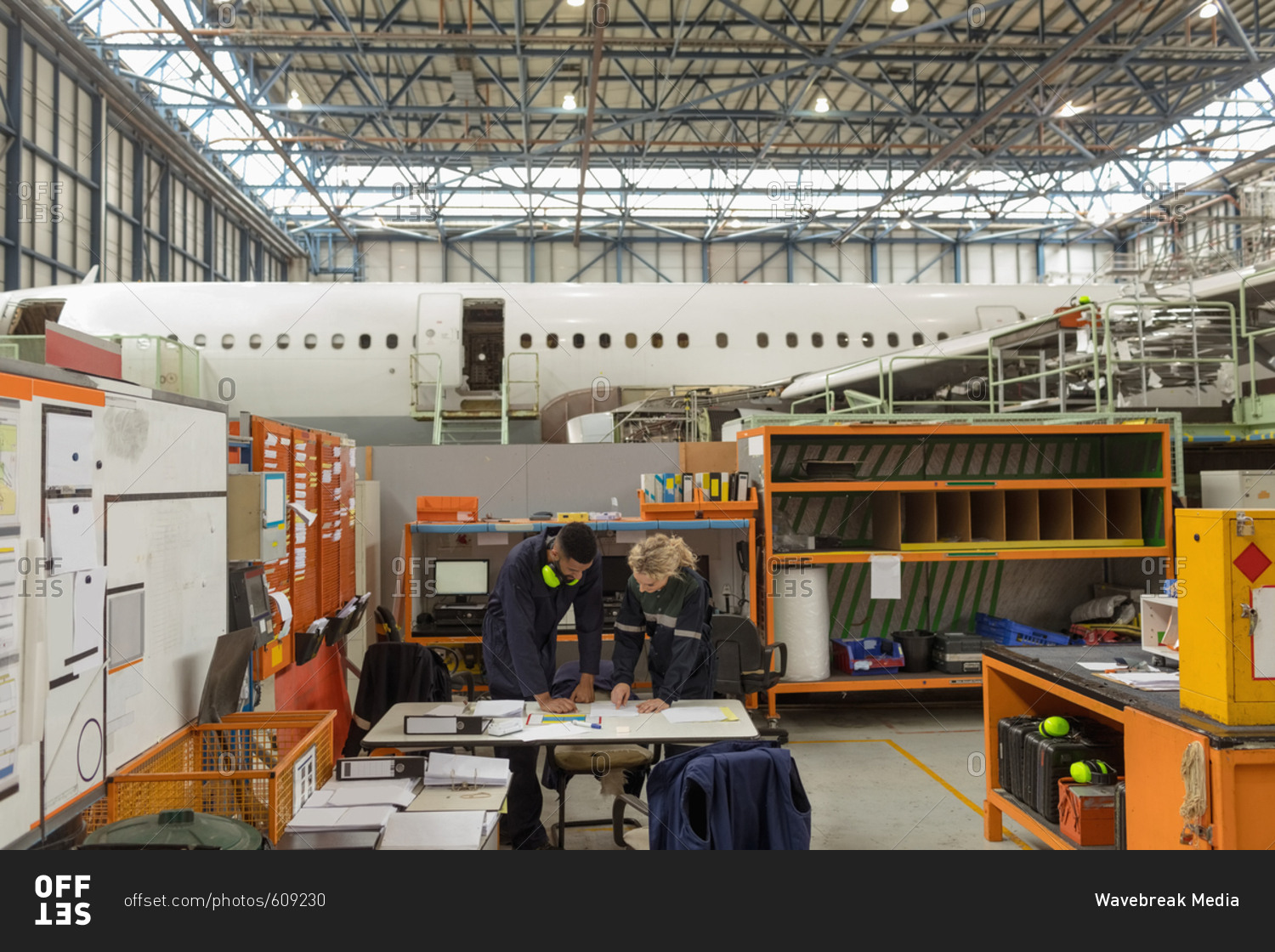 Aircraft maintenance interacting with each other at airlines maintenance facility