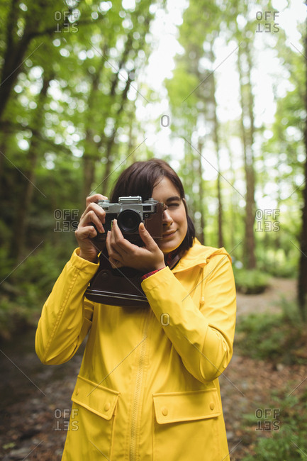 Woman clicking photos of nature in forest