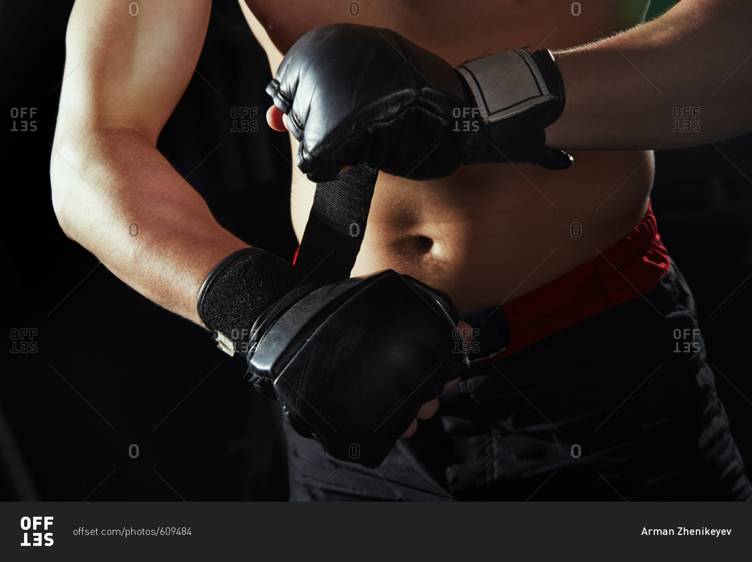Martial art fighter fastening gloves