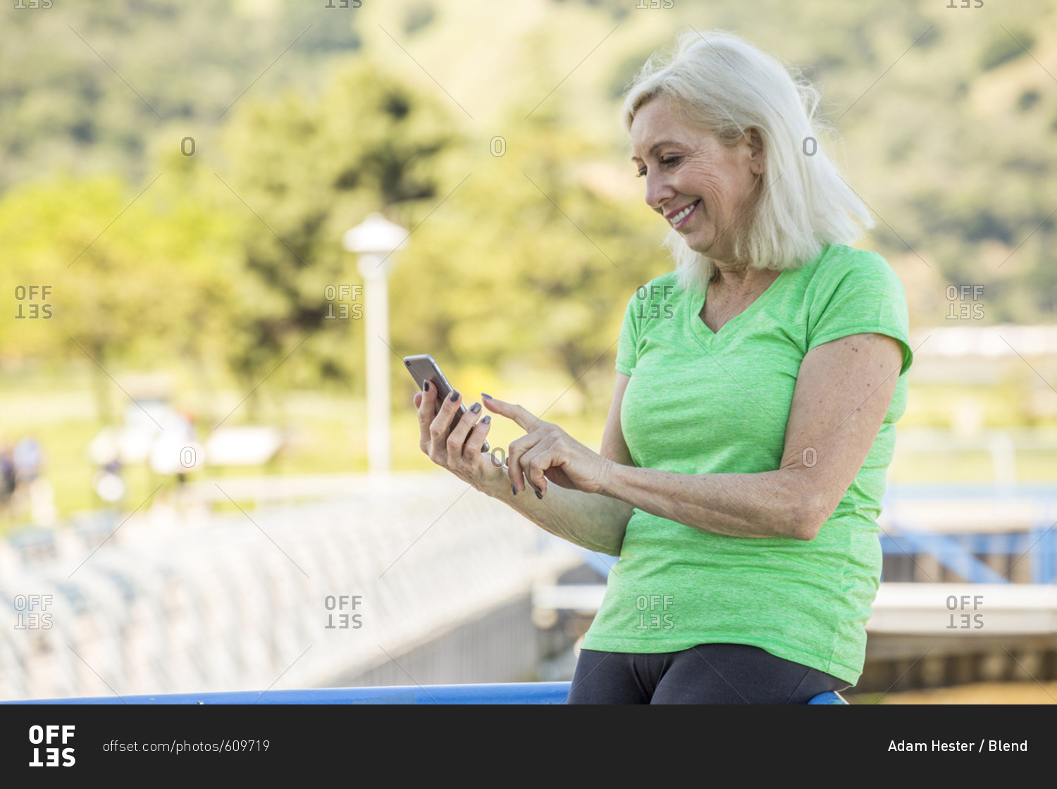 Older Caucasian woman texting on cell phone outdoors