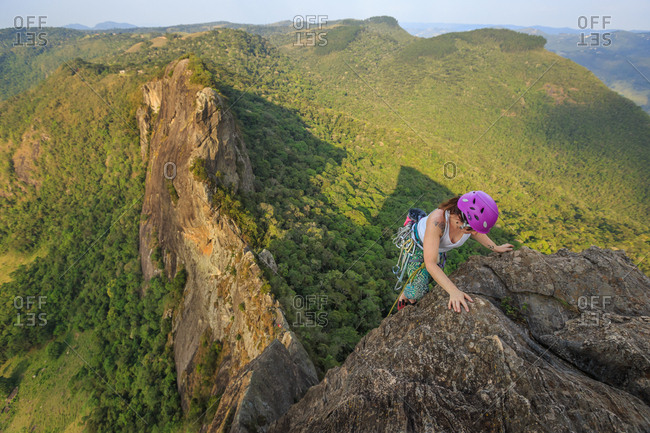 Woman climbing a mountain in Pedra do Bau