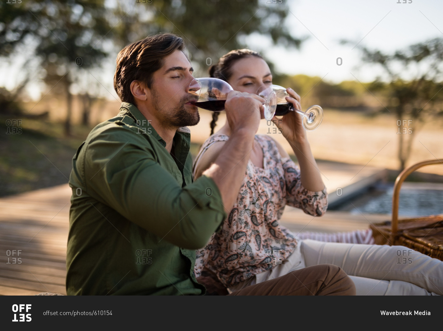 Romantic couple drinking red wine during safari vacation