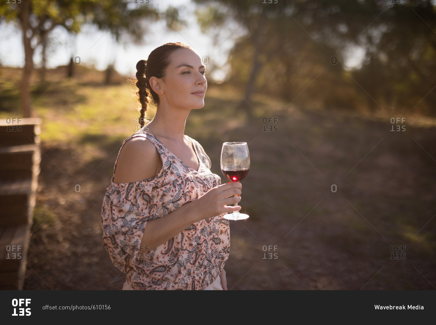 Thoughtful woman having a glass of wine during safari vacation