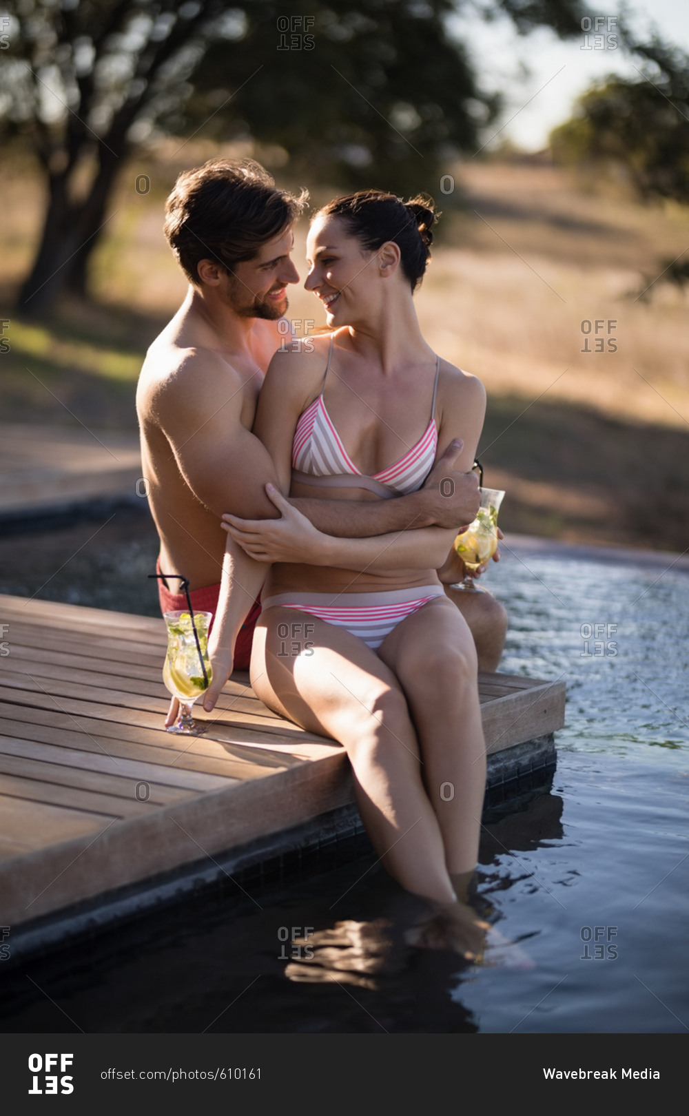 Happy couple relaxing in pool during safari vacation