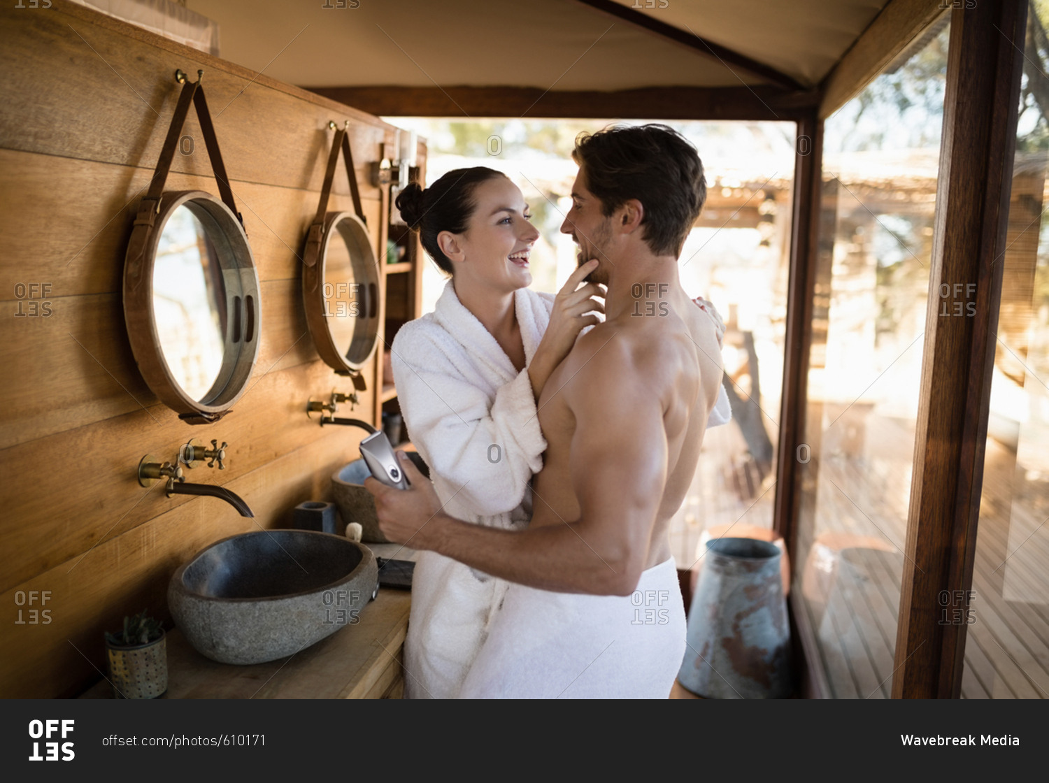 Couple having fun together in cottage during safari vacation