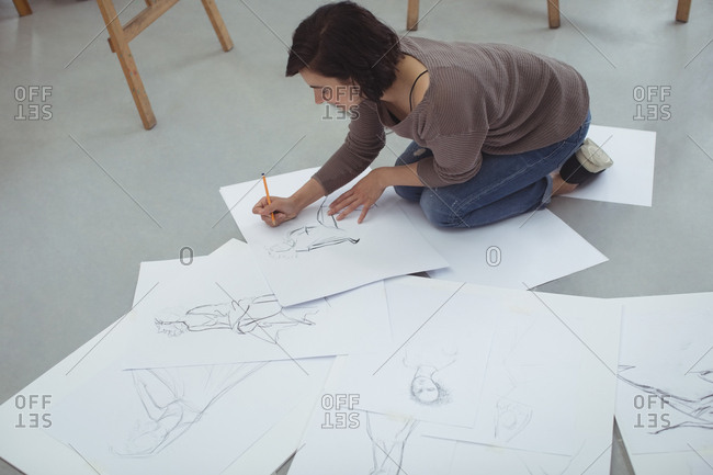 Artist drawing sketch on paper in art studio