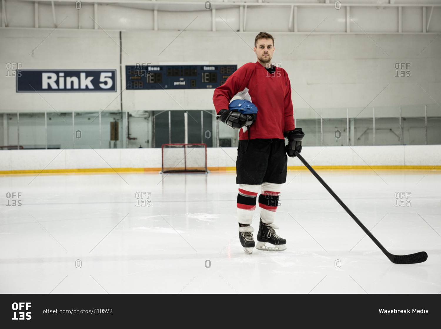 Hockey Player Standing on the Ice Rink while Holding a Stick · Free Stock  Photo