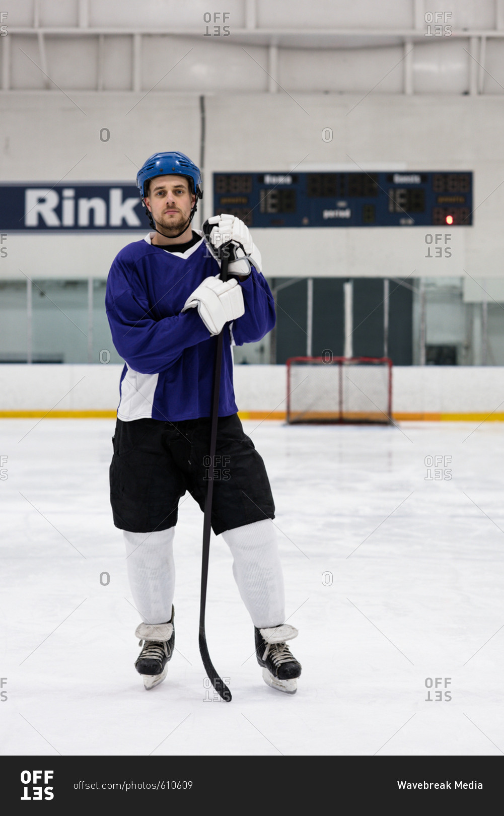 Full Length Portrait Of Male Ice Hockey Player Holding Stick At Rink Stock Photo Offset