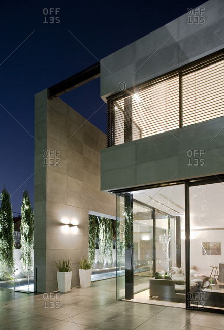 Herzliya, Israel - September 14, 2017: Exterior view of UP House in the evening, grey limestone and glass facade with adjoining swimming pool