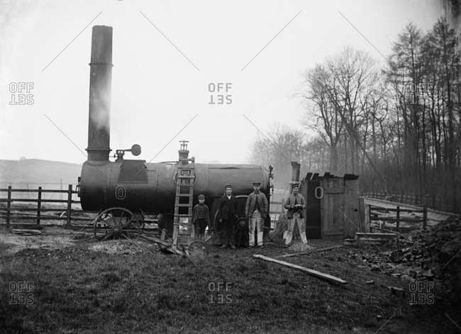 Charwelton, Northamptonshire, England, UK - CIRCA 1900: Construction workers on Great Central Railway with a large steam engine for power and a small makeshift hut for shelter at the ironstone quarry
