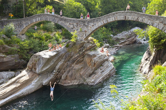 July 7, 2013: View Of a Diver Leaping From Ponte Dei Salti Bridge Over River At Valle Verzasca, Switzerland
