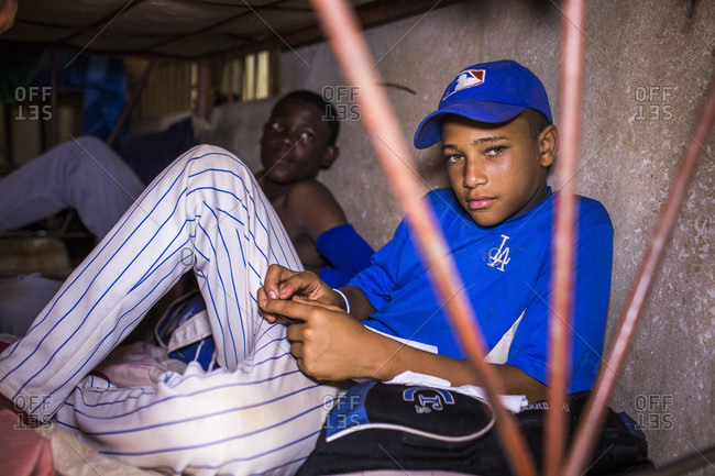 September 12, 2017: Two Baseball Players In Uniform Sit On A Bunk bed Mattress In A Dark Concrete Room In The Dominican Republic