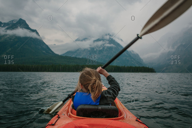 Boy kayaking in mountain setting