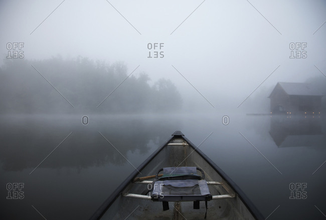 Boat in lake against sky during foggy weather