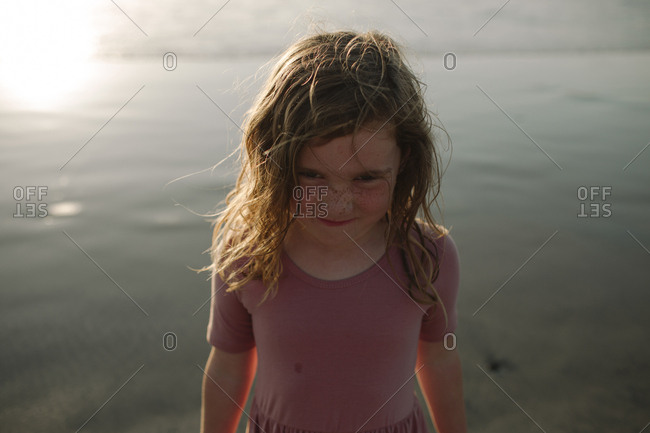 High angle portrait of frowning girl at beach