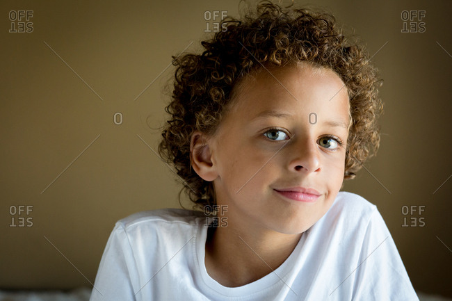 Portrait Of A Smiling Mixed Race Boy With Curly Hair Stock