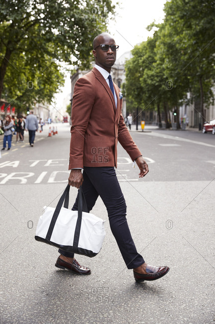 London, England - June 11, 2017: Fashion blogger and writer Anton J Welcome crossing the street during London Fashion Week Men's