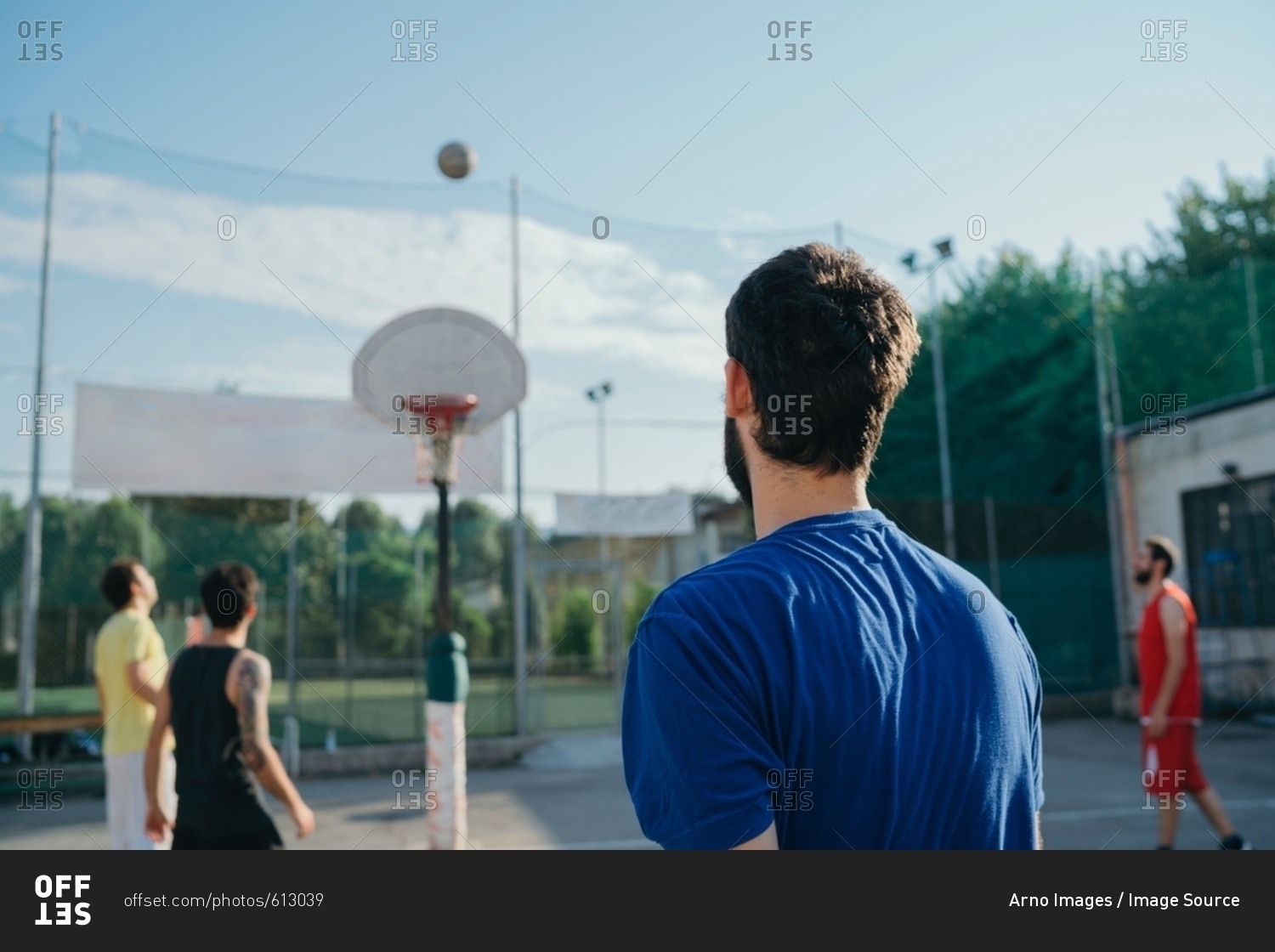 Friends on basketball court playing basketball game