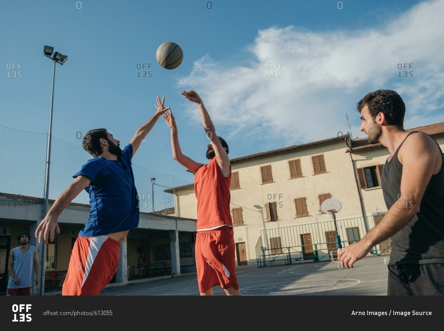 Friends on basketball court playing basketball game