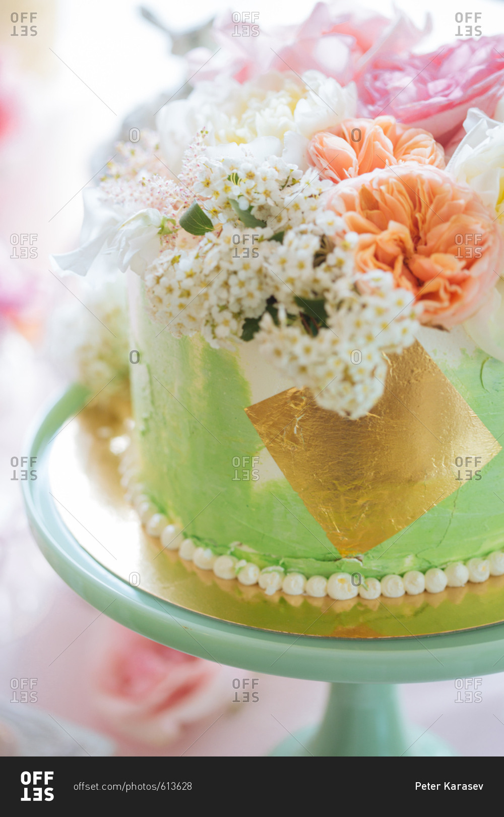 Green and gold cake topped with flowers