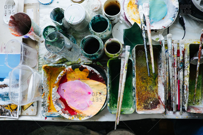 Messy workshop filled with painting supplies stock photo - OFFSET