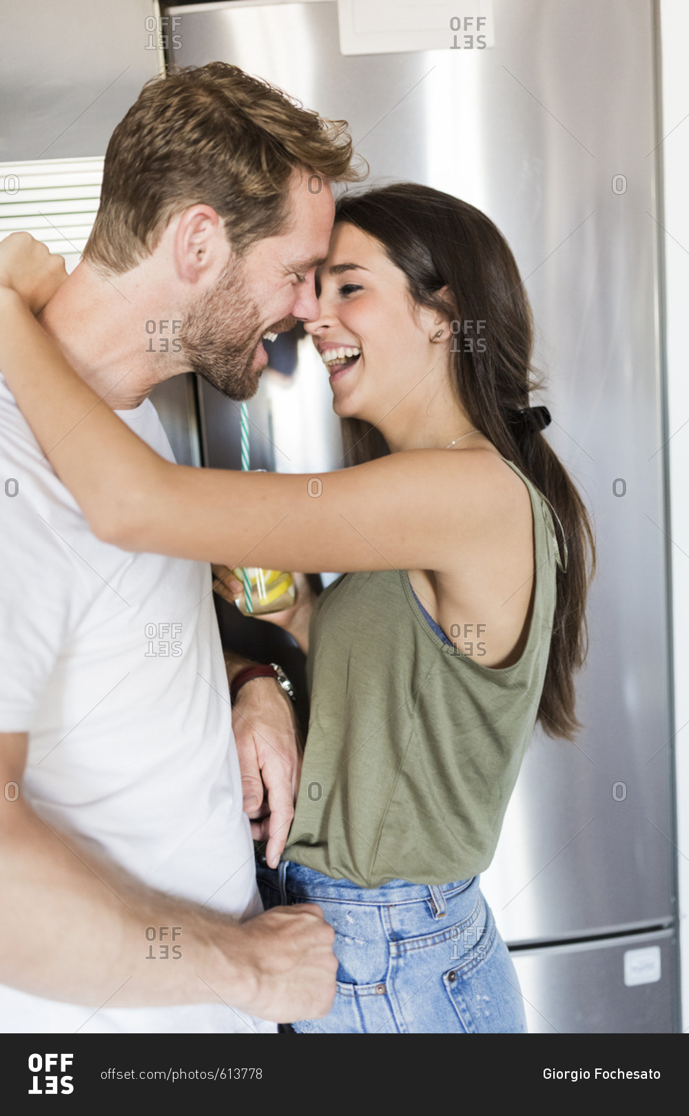 Couple smiling by fridge