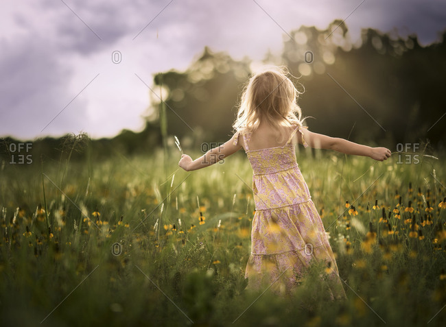 Girl being playful in field