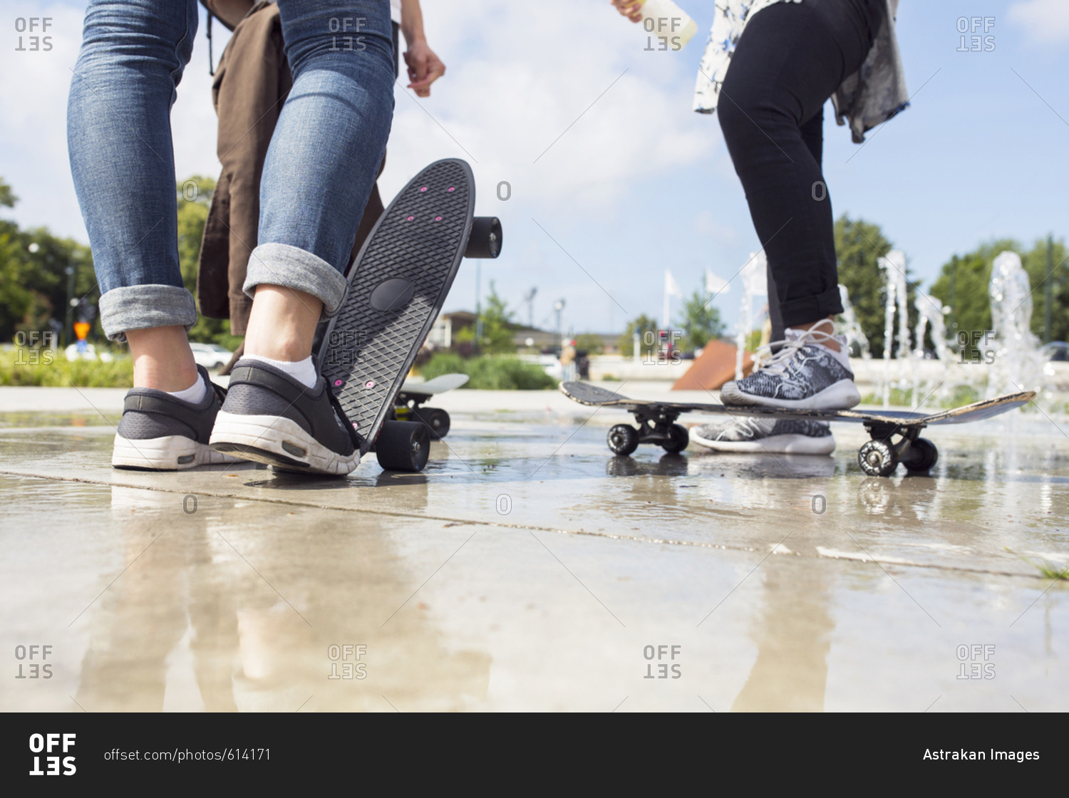 Low section of teenage girls (14-15) and teenage boy (16-17) hanging out in skateboard park