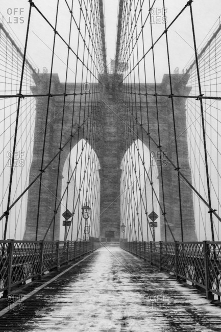 The Brooklyn Bridge is a hybrid cable-stayed/suspension bridge in New York City and is one of the oldest bridges of either type in the United States. Completed in 1883, it connects the boroughs of Manhattan and Brooklyn by spanning the East River