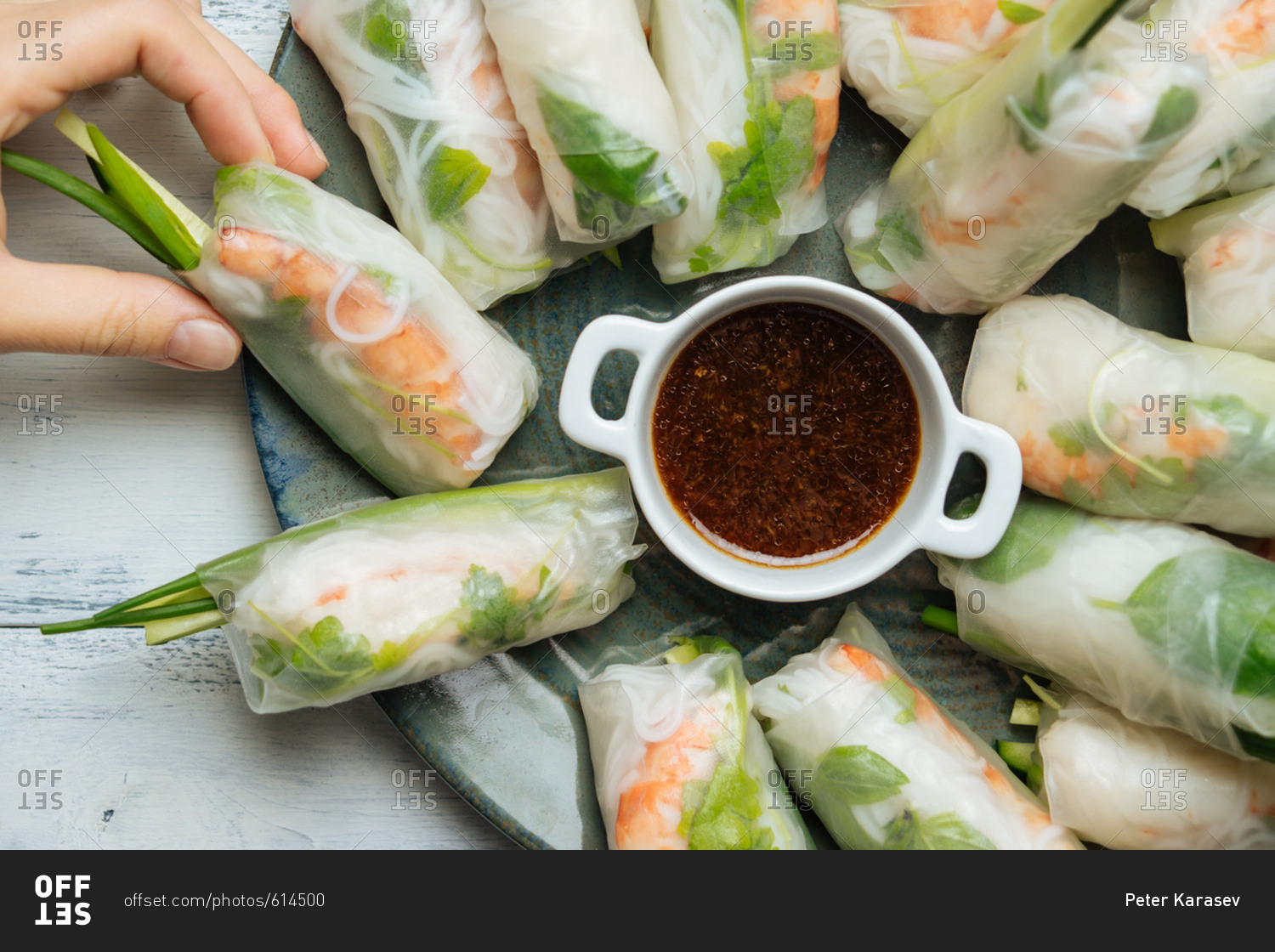 Hand grabbing a Vietnamese spring roll with shrimp